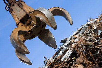 Crane grabbing metal